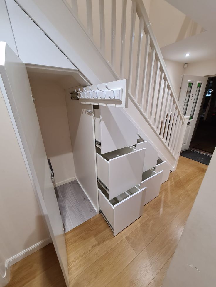 an open staircase with drawers underneath it