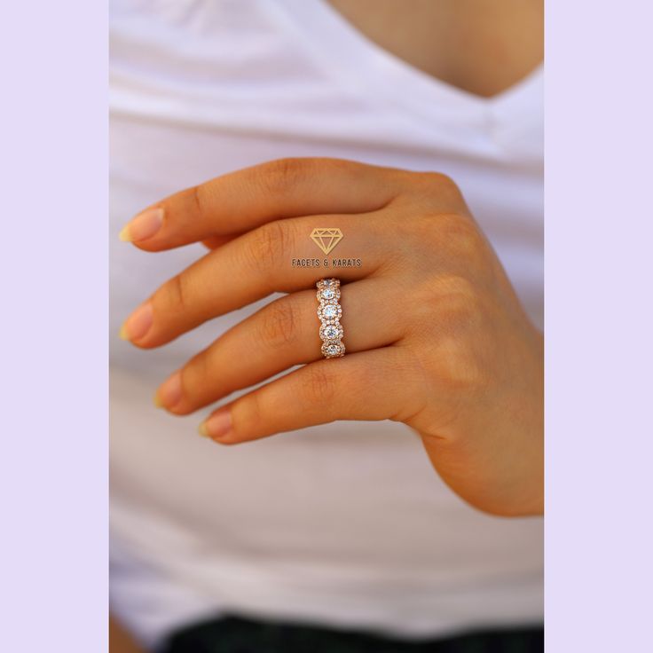 a woman's hand with a diamond ring on it