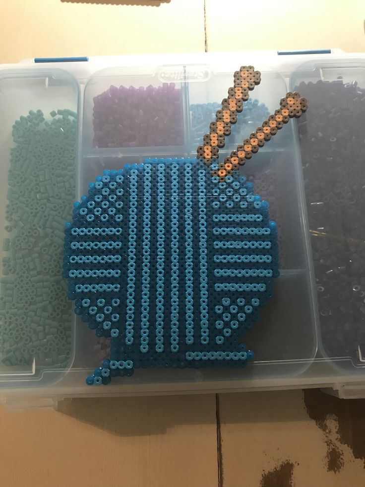 a plastic container filled with lots of different colored beads