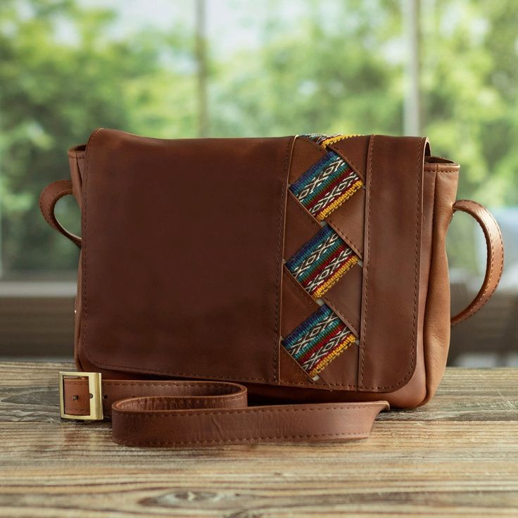 "Concentrating on leather handbags and accessories, creates this refined shoulder bag perfect for carrying the daily essentials on a walk to the summer fair. The bag features an adjustable leather strap, Incan motif trim on the exterior leather flap and a polyester-lined interior closing with a zipper. 1.2 lbs Bag: 7.75\" H x 10.25\" W x 2\" D Strap(s): 50\" min L - x 56\" max L x 1.1\" W Drop length: 21.75\" min L - x 25\" max L Leather, wool trim, polyester lining Features a zipper closure Adj Leather Flap Bag For On-the-go, Leather Hobo Shoulder Bag With Adjustable Strap, Leather Satchel Shoulder Bag, Leather Shoulder Bag With Adjustable Strap For Daily Use, Leather Tote With Adjustable Strap, Leather Tote Flap Bag With Adjustable Strap, Leather Satchel Flap Bag For On-the-go, Leather Satchel With Removable Pouch, Crossbody, Travel Clutch Flap Bag With Adjustable Strap