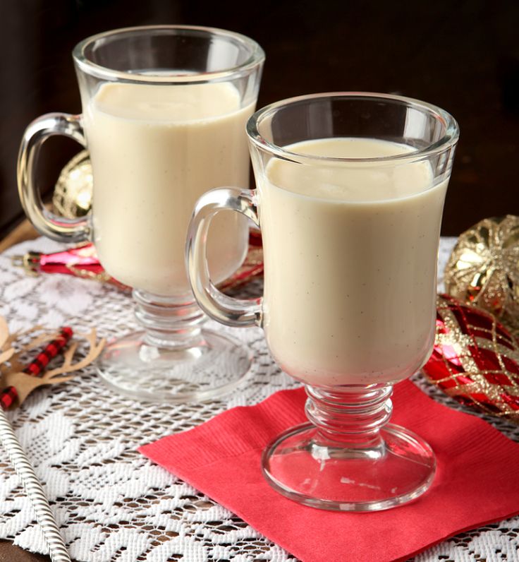 two glasses of milk sitting on top of a table