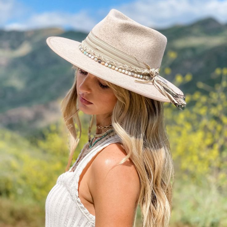 The Moonshine - Womens Cream Felt Fedora Hat doesn't come with any moonshine but they'll be blackbirds singing your praises in the dead of night as the moon shines on your luxurious American Hat Makers Moonshine. Material: Wool Felt Rustic frayed fabric hat band Brim 3 3/4" Crown 4 1/2" Beaded Hat Band with Feather Chinstrap Sizing Info Measuring for the Moonshine - Womens Cream Felt Fedora Hat begins by wrapping a soft measuring tape (also known as a tailor's tape or sewing tape) around your he White Fedora Hat, White Fedora, Womens Fedora Hat, Frayed Fabric, Blackbird Singing, Hat Decor, American Hat Makers, American Hat, Dead Of Night