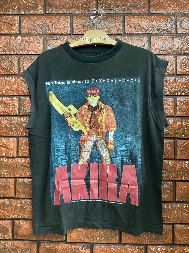 Distressed Akira Japanese Cyber Punk Anime 1988 Movie Poster Sleeveless T Shirt / Japanese Cyberpunk Anime / Pop Culture T Shirt Size L Condition : Heavy Used Size on tag : L (Resized) Colour : Black Brand : Unknown Measurement : Armpit to armpit - 22" Length - 27" Material : Cotton Made In: Unknown THE SHIPPING (Your Choice Please read) 1. The shipping cost is USD 20 via Malaysian Registered Postage With Tracking Number. It will take 2-4 weeks or more for delivery, depends on your custom checki Punk Sleeveless Cosplay Tops, Punk Style Sleeveless Tops For Cosplay, Punk Sleeveless Tops For Cosplay, Alternative Sleeveless Cosplay Tops, Punk Tank Top For Cosplay, Punk Style Sleeveless Tank Top For Cosplay, Edgy Tank Vest With Graphic Print, Grunge Graphic Print Vest For Streetwear, Japanese Cyberpunk