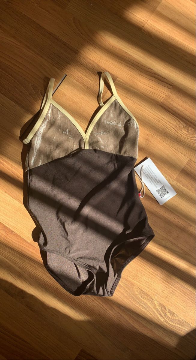 a bathing suit laying on top of a wooden floor