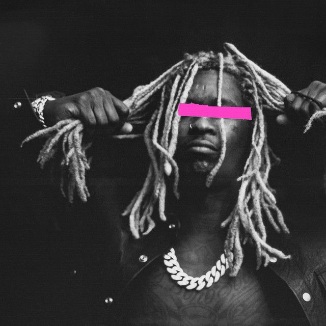 a man with dreadlocks and pink tape on his face is standing in front of a black background