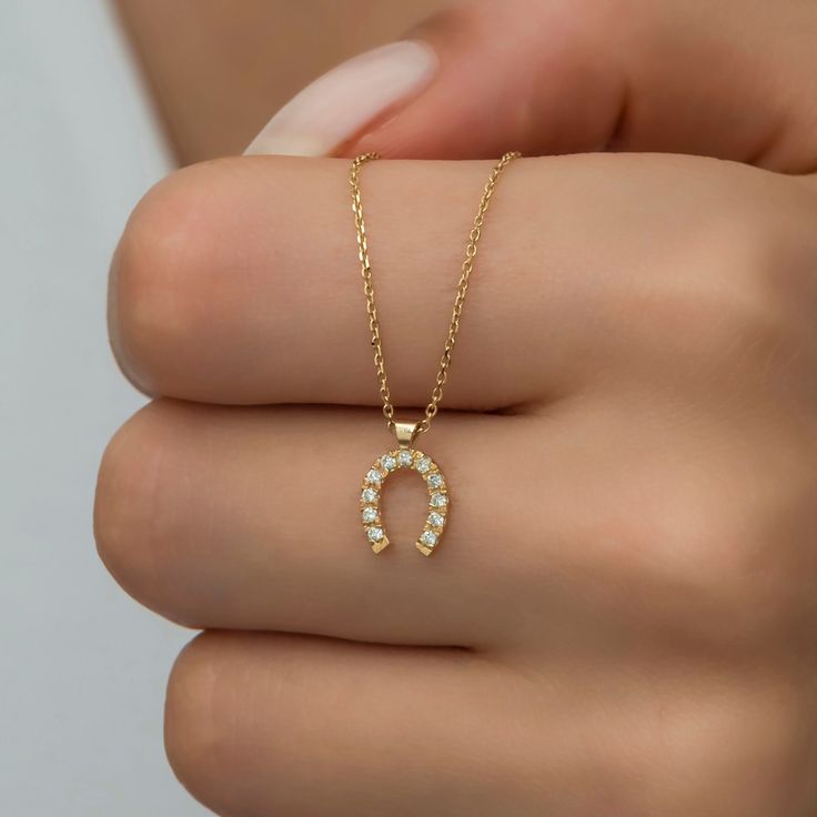 Features Yellow gold, white diamond Material: Solid Gold (not gold plated or gold filled) Available Gold Color: Yellow gold, rose gold and white gold Karat: 14 K (585) Diamond weight: 0.13 ct Gold grams: 1.95 gr Diamond color: F-G Color Chain length: approximately 16.5 in / 42 cm Available with or without chain Made to order Available in 4 different chain lengths: 42 cm (16.5 in), 45 cm (18 in), 47 cm (18.5 in) or 49 cm (19 in). Model wears the 42 cm length. As with all of our products, this ite Yellow Gold Horseshoe Jewelry For Anniversary, Gold Hallmarked Horseshoe Jewelry, Gold Horseshoe Jewelry With Adjustable Chain, Gold Horseshoe Jewelry For Anniversary, Horseshoe Shaped Yellow Gold Jewelry Gift, Horseshoe-shaped Yellow Gold Jewelry Gift, Gold Diamond Horseshoe Jewelry, Gold Horseshoe Diamond Jewelry, Gold Horseshoe Necklace For Gift