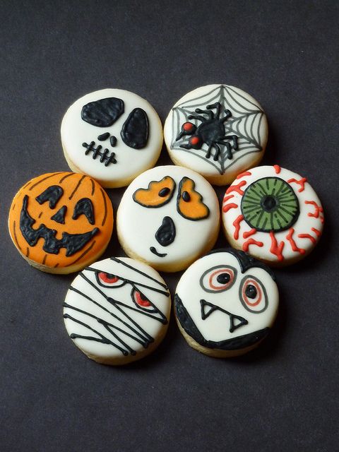 a group of decorated cookies sitting on top of a table next to each other in front of a facebook page