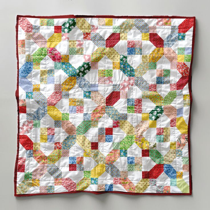 a colorful quilt is hanging on the wall