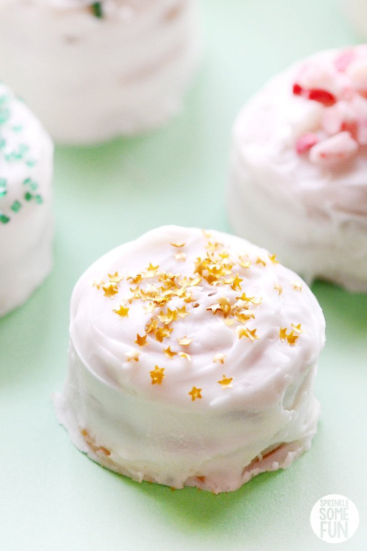 some white frosted pastries with sprinkles on them