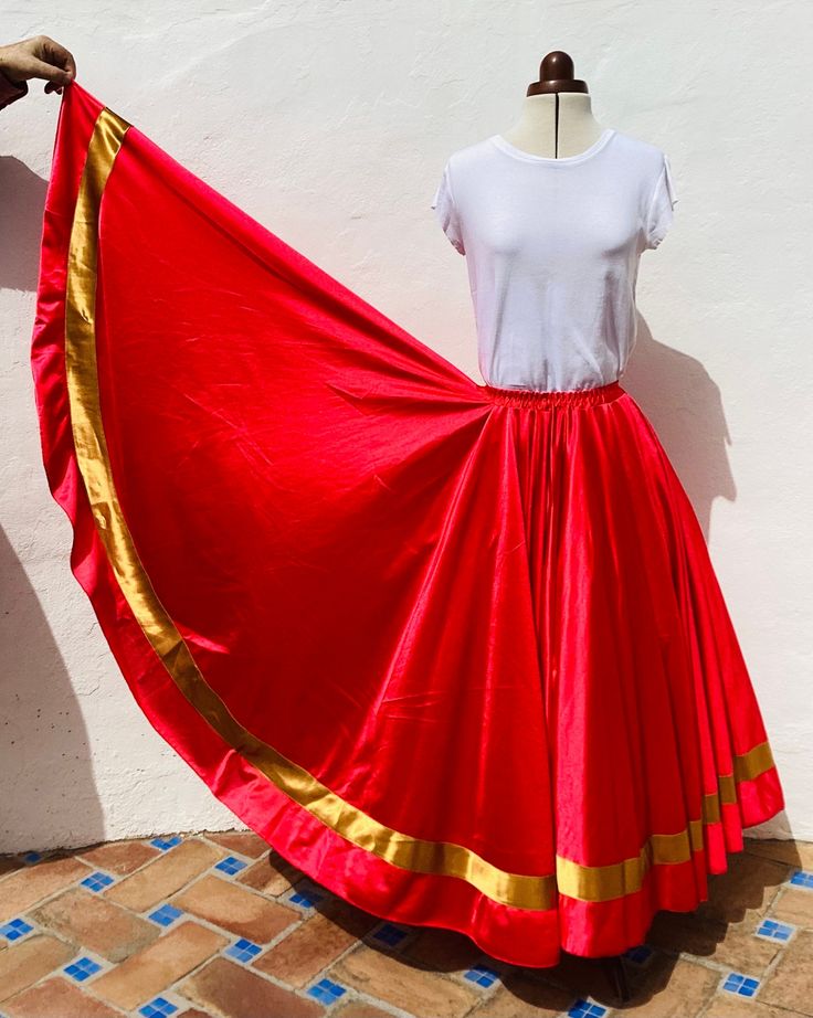 Authentic Spanish Skirt from Andalucia in Southern Spain Brilliant Red Flamenco Dance Skirt with Gold Satin Ribbon  Measurements Elastic Waistband stretches from 18"(46cm) to 34"(86cm) Hips - freesize Length 34.5"(88cm) Full Length and XXL Full Circle ( more than a circle) 100% Polyester Machine Washable 2"(5cm) Wide Gold Satin Ribbon at the hemline Excellent Condition Weight 800gms - good weight, falls well DANCE/PERFORMANCE/COSTUME/FIESTA/CARNIVAL/COSPLAY Ref: FB10/SK3 Shipping I usually send Festival Belly Dance Fitted Skirt, Traditional Skirt For Dance Festivals, Traditional Long Skirt For Dance, Belly Dance Skirt For Dance Festivals, Belly Dance Festival Skirt, Festival Dance Skirt, Fitted, Fitted Festival Skirt For Dance, Festival Fitted Skirt For Dance, Fitted Skirt For Dance Festivals