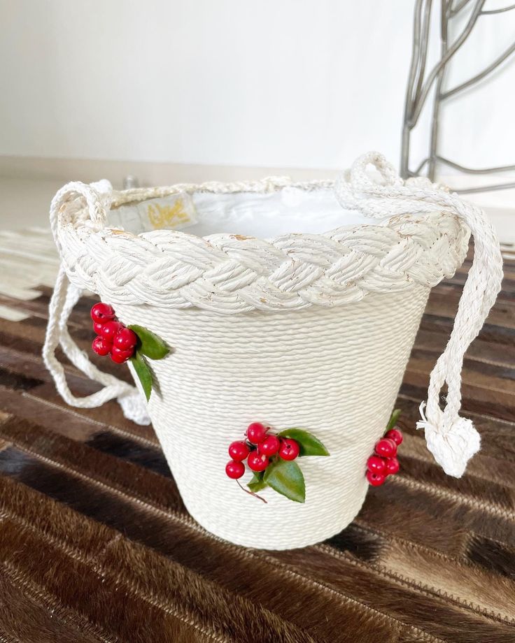 "Sweetest bucket bag ever! Pristine white rope bucket bag with beautiful red cherries peppered on the front. This is such a lovely summer bag. Fits tonnes. Condition: Very good. Some loss of white paint on the trim but not obvious when carried. The lining seems a little \"rough\" around the seams but again, doesn't detract from how lovely this baby is. Label: K& G Charlet Measurements: Top side to side 9\" Bottom side to side 5\" Top to bottom (excluding handle) 8.5\" Handle drop 12\" This item White Bucket Bag As A Gift, White Bucket Shoulder Bag As A Gift, White Bucket Bag For Beach, White Bucket Shoulder Bag For Summer, Summer White Bucket Shoulder Bag, White Basket Bucket Bag For Beach, White Basket-shaped Bucket Bag For Beach, White Bucket Bag For The Beach, White Beach Bucket Bag Basket