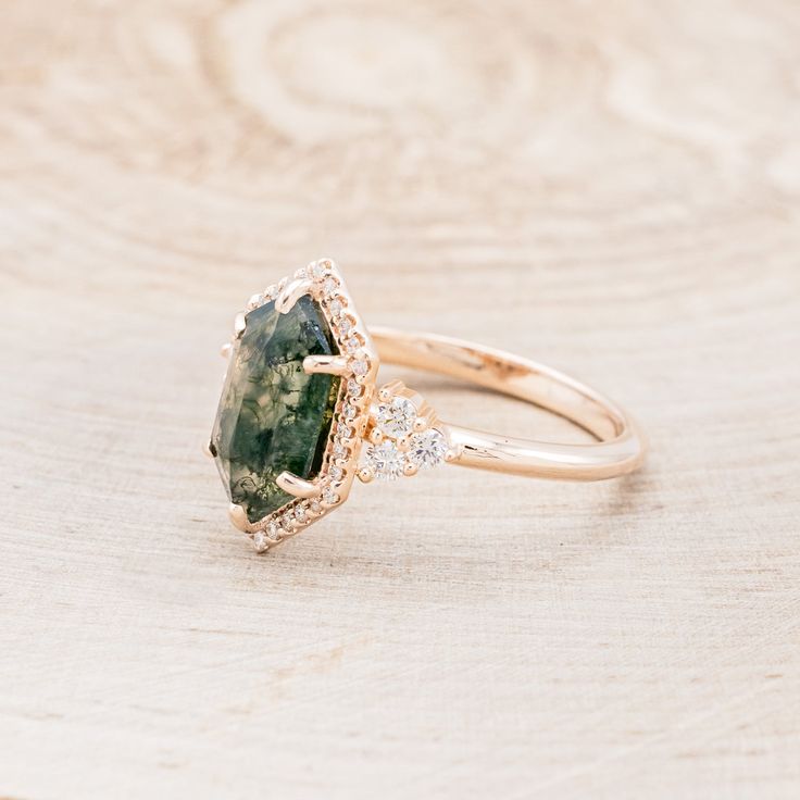 Ring Style: The "Octavia" is a hexagon moss agate women's engagement ring with a diamond halo and accents Center Stone: 11x7mm Elongated Hexagon Cut Moss Agate Accent Stones: 1/4ctw (32) 0.9mm Round Diamonds (6) Round Diamonds Available In: 14K White Gold, 14K Yellow Gold, or 14K Rose Gold Customizable: Because each ring is handcrafted to order we can customize center or accent stones, use unique materials, customize design features, or even use your own personal materials that you send us! To d Fairytale Engagement Rings, Hexagon Engagement Ring, Ring Upgrade, Moss Agate Engagement Ring, Future Engagement Rings, Agate Engagement Ring, Moss Agate Ring, Ring With Diamond, Detailed Ring