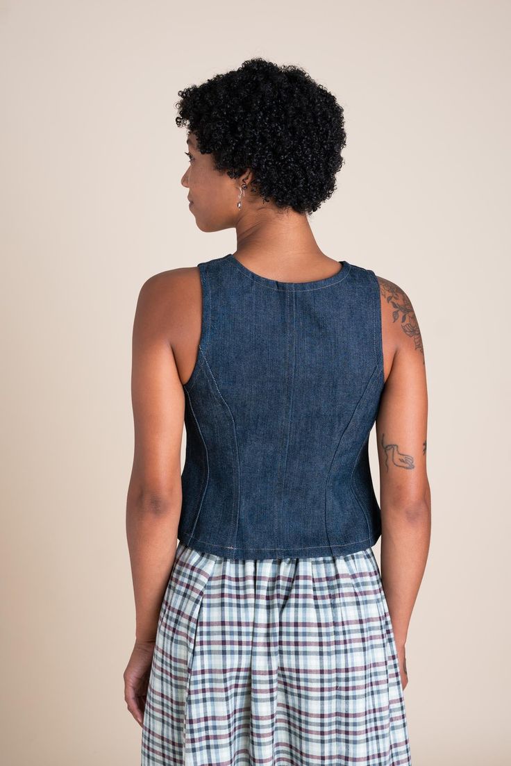 The Katherine Vest is inspired by a family heirloom passed down to Elaina. It features detailed paneling on the front and back, just like the original piece, along with brass snaps, 12 oz high-quality denim, and a flared silhouette. Once this limited-edition denim is gone, it's gone for good. Fitted Denim Blue Jeans With Snap Buttons, Fitted Denim Top With Button Closure, Fitted Dark Wash Pre-washed Jeans, Fitted Dark Wash Jeans With Snap Buttons, Fitted Jeans With Snap Buttons, Dark Wash Cotton Denim Top With Snap Buttons, Fitted Cotton Denim Vest With Button Closure, Dark Wash Denim Top With Snap Buttons, Fitted Vintage Denim Top With Buttons