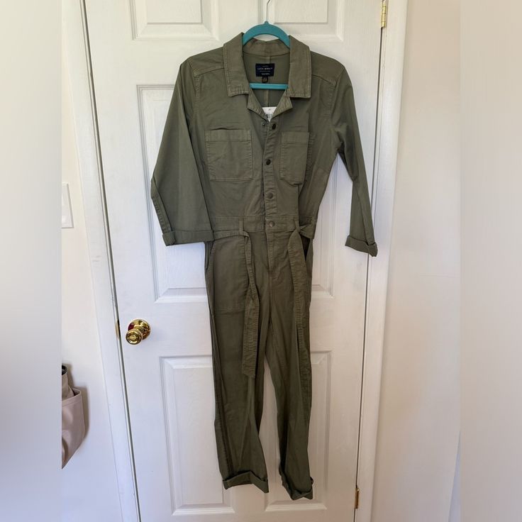 Lucky Brand Jumpsuit. Olive Green Khaki. Button Front And Tie Waist. Size 27 (4). Nwt Khaki Utility Overalls For Workwear, Utility Overalls With Button Closure And Relaxed Fit, Casual Overalls With Button Closure For Workwear, Cotton Jumpsuits And Rompers With Buttons For Fall, Utility Overalls With Button Closure, Utility Style Jumpsuits And Rompers With Button Closure, Utility Button-up Overalls For Workwear, Utility Style Relaxed Fit Jumpsuits And Rompers, Utility Jumpsuits And Rompers With Relaxed Fit And Button-up