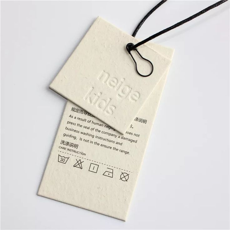 two tags attached to strings on a white surface