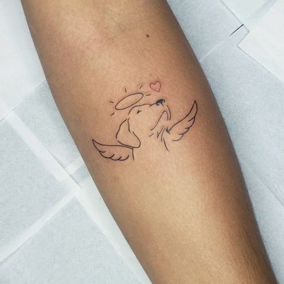 a small tattoo on the arm of a person with a dog's head and wings