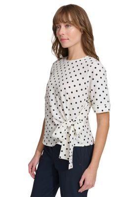 Classic polka dots decorate this blouse from Tommy Hilfiger. | Tommy Hilfiger Women's Short Sleeve Dot Tie Front Blouse, Medium Elegant Polka Dot Tops For Work, Polka Dot Short Sleeve Spring Tops, Tommy Hilfiger Casual Blouse For Spring, Casual Tommy Hilfiger Blouse For Spring, Tommy Hilfiger Casual Spring Blouse, Elegant White Tommy Hilfiger Tops, Elegant Polka Dot Tops For Summer, Spring Polka Dot Cotton Tops, Tommy Hilfiger Blouse For Spring Workwear