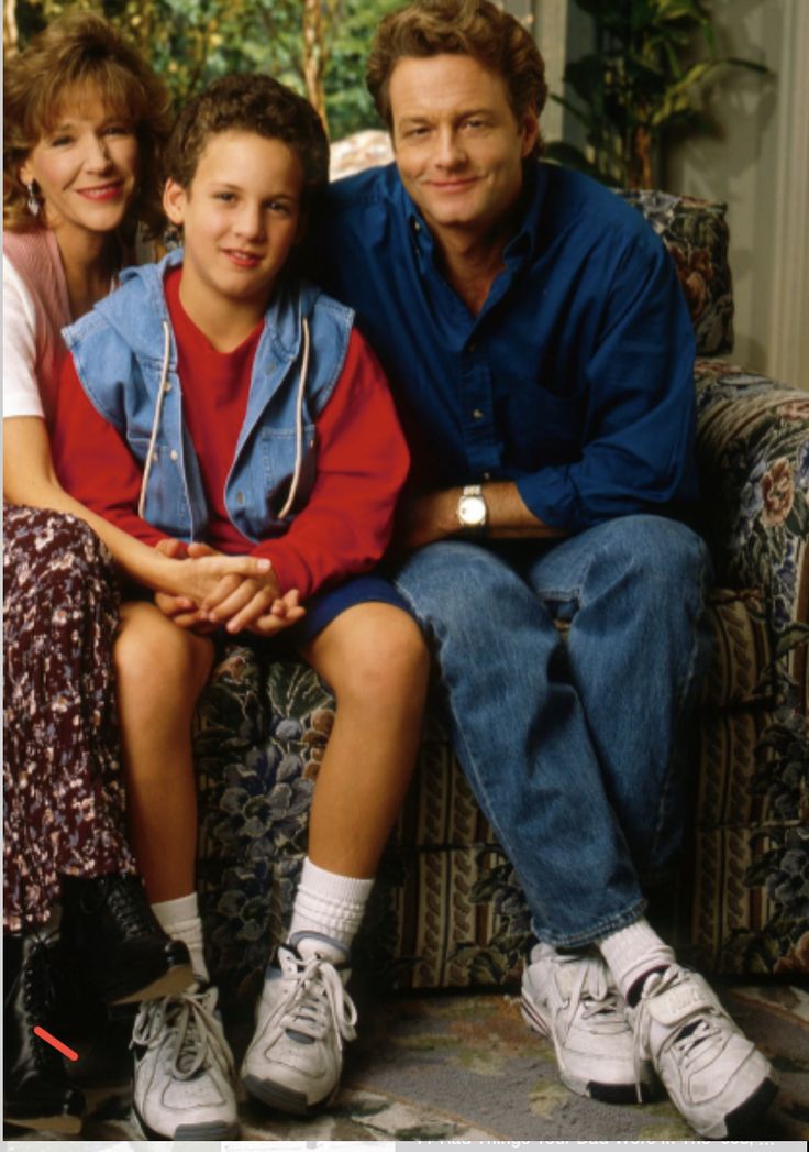 a man and two children sitting on a couch