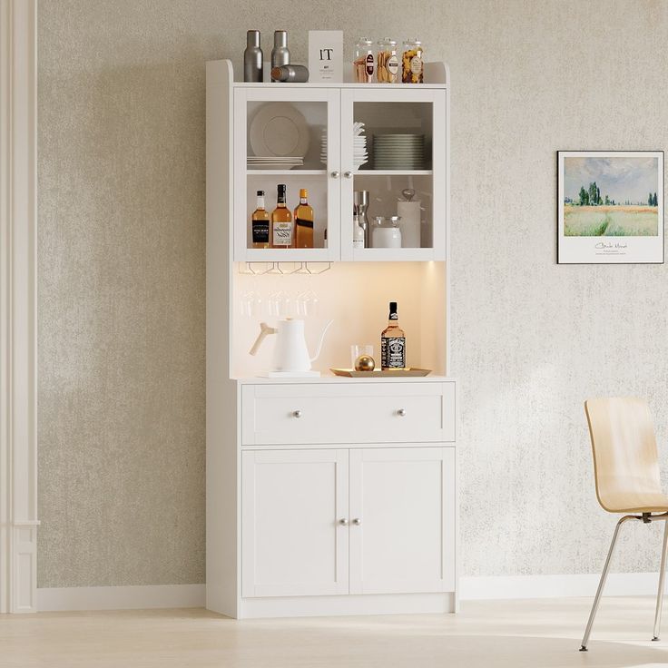 a white cabinet sitting next to a chair in a room