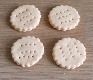 four small crackers sitting on top of a wooden table