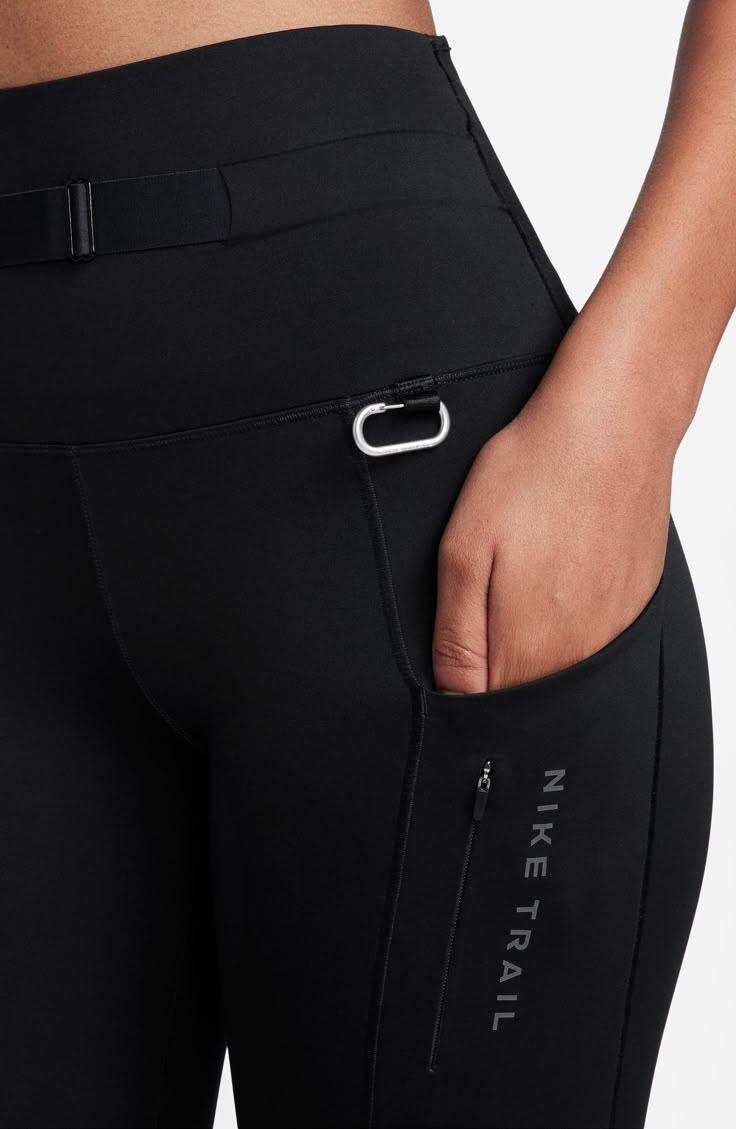 A high waist helps reduce rolling, pinching and sliding in trail-ready leggings made with Dri-FIT technology that keeps you cool and comfy. A detachable ripstop side pack and small carabiner allow you to carry all essentials so you're ready for any adventure. 25" inseam; 8" leg opening; 10" front rise; 13" back rise (size medium) Dri-FIT moisture-wicking technology Side drop-in pockets; side hidden-zip pocket; three back waist drop-in pockets Detachable zip side pack Reflective details enhance visibility in low light or at night 80% polyester, 20% spandex with 100% polyester gusset Machine wash, dry flat Imported Workout Clothes Black Women, Fitness Fashion Active Wear, Hiking Leggings, Chic Activewear, Low Rise Leggings, Fitness Activewear, Gym Fits, Leggings With Pockets, Best Leggings