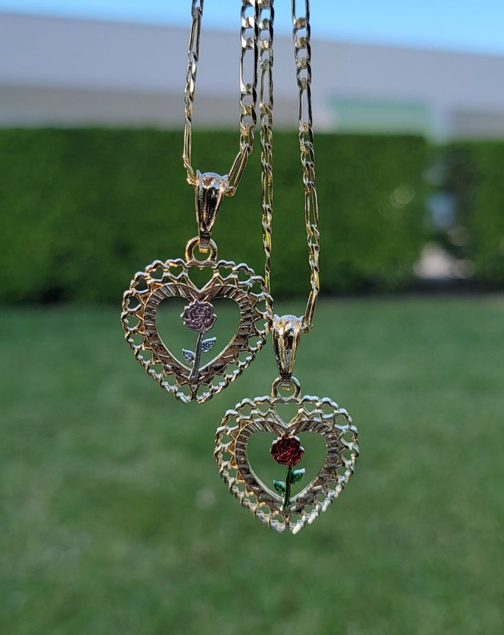 Whether to dress up, or dress down, this piece is truly the perfect accessory for any wardrobe or style! Pendant Height: 1.25" inch Includes 20" inch chain 14K Gold Plated Figaro Chain Jewelry With Heart Pendant, Heart-shaped Rose Design Necklace For Valentine's Day, Valentine's Day Heart Pendant Necklace With Rose Design, Tarnish Resistant Rose Gold Heart Pendant Necklace, Rose Gold Tarnish Resistant Heart Pendant Necklace, Rose Heart Necklace For Valentine's Day, Valentine's Day Rose Heart Necklace, Mother's Day Heart Pendant Jewelry With Rose Design, Mother's Day Heart Pendant With Rose Design