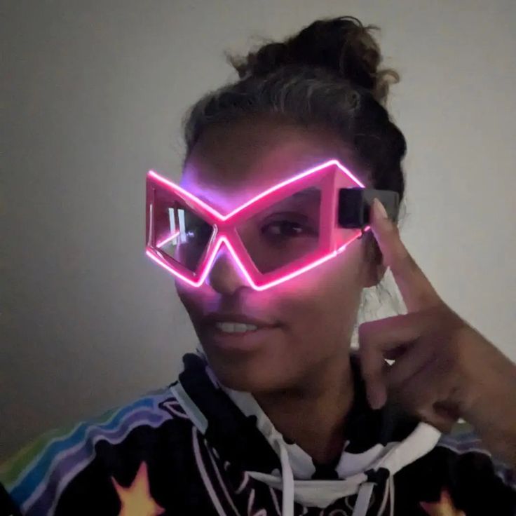 a woman wearing pink glasses with stars on it