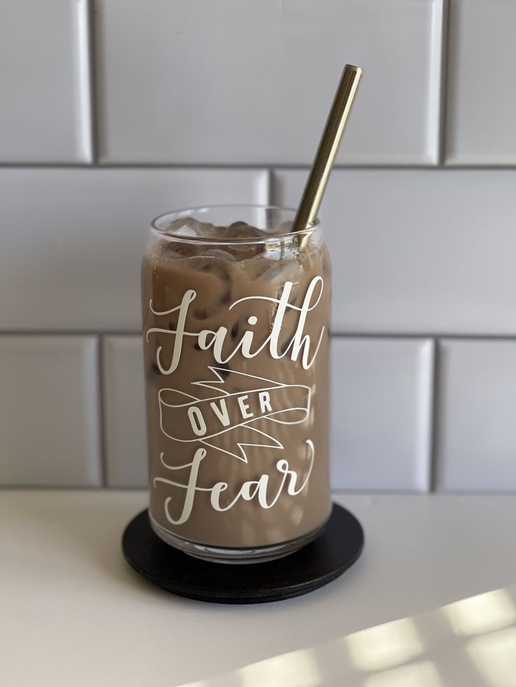 a cup with a straw in it sitting on top of a table