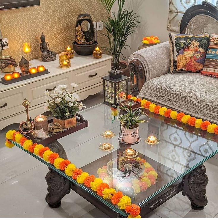 a living room filled with lots of furniture and flowers on top of glass coffee table