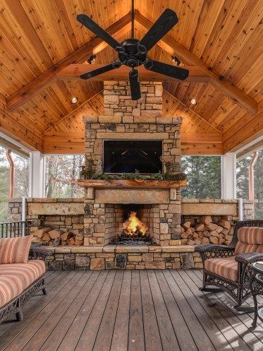 an outdoor living area with fireplace and chairs