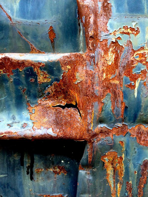 an old rusted metal surface with peeling paint