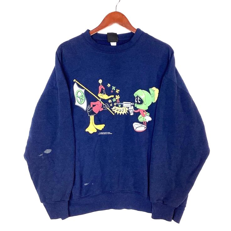 Vintage Daffy Duck Marvin the Martian Sweatshirt Crewneck Extra Large Blue 1993 Size/Measurements (Based in inches) Size - Extra Large Pit to pit - 25.5" Length - 28" Shoulder to cuff - 22" Condition / Details Cracking found on the print Discolouration found on the front, on the right sleeve and on the back waist hem Combined Shipping: We provide combined shipping, please contact us for a quote Vintage Blue Sweatshirt With Graphic Print, Vintage Blue Crew Neck T-shirt, Blue Crew Neck Sweatshirt For Fan Merchandise, Retro Blue Sweatshirt With Screen Print, Blue Fan Apparel Sweatshirt With Graphic Print, Blue Graphic Print Fan Apparel Sweatshirt, Marvin The Martian, Daffy Duck, Sweatshirt Crewneck