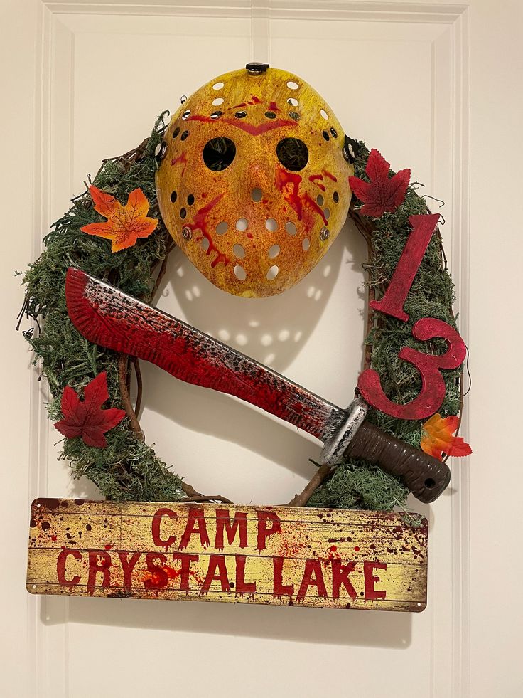 a hockey mask is hanging on the wall next to a sign that says camp crystal lake