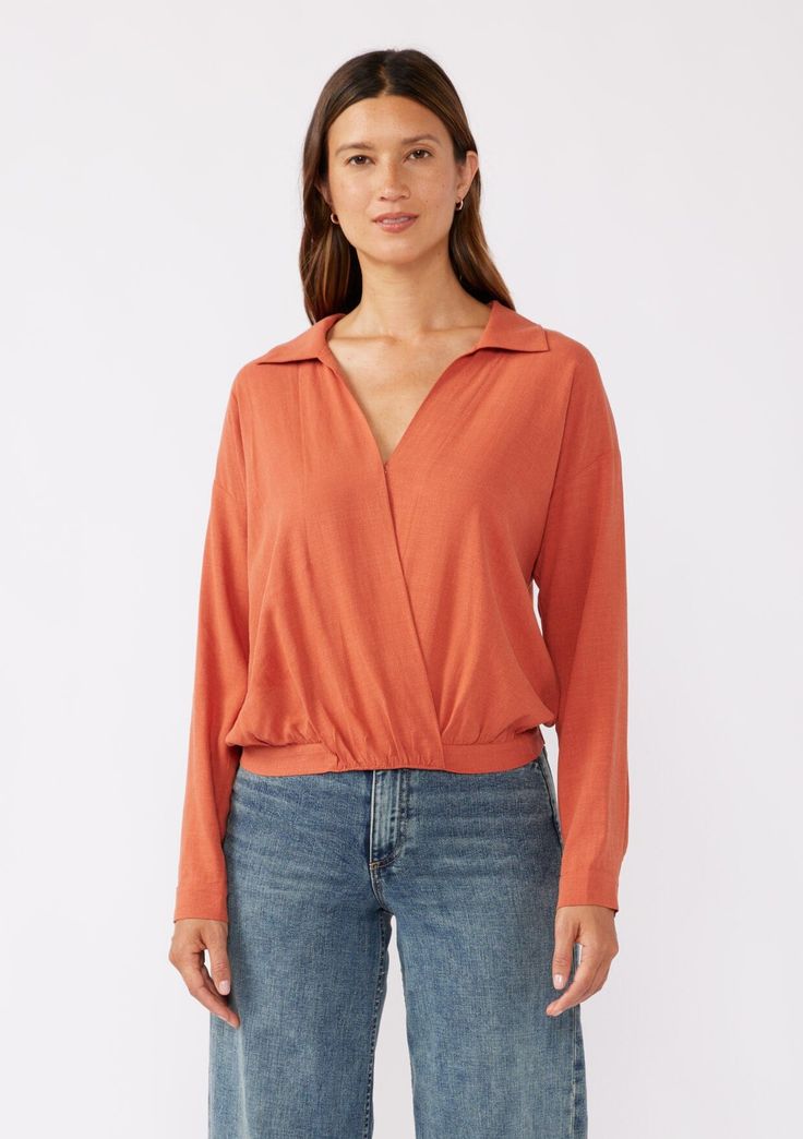 Keep it effortlessly chic this Fall in our surplice front blouse. A casual top with endless styling possibilities. Featuring a flattering surplice v-neckline, a classic collar neckline, and a relaxed silhouette. This versatile top is perfect for the office or post-work cocktails! Linen blend Relaxed fit Long sleeve Dropped shoulder Button cuff closure V-neckline Collared neckline Hook & eye closure Half elastic waist at the back Dry clean recommended or hand wash cold Model is 5'7.5, wearing a s Modern V-neck Top For Spring, Trendy V-neck Top With Twist Front, Solid Color V-neck Faux Wrap Top, Versatile Long Sleeve V-neck Top For Work, Chic Surplice Neckline Tops, Chic Solid Surplice Neckline Tops, Versatile Solid Color V-neck Top, Modern V-neck Blouse For Work, Modern V-neck Workwear Blouse