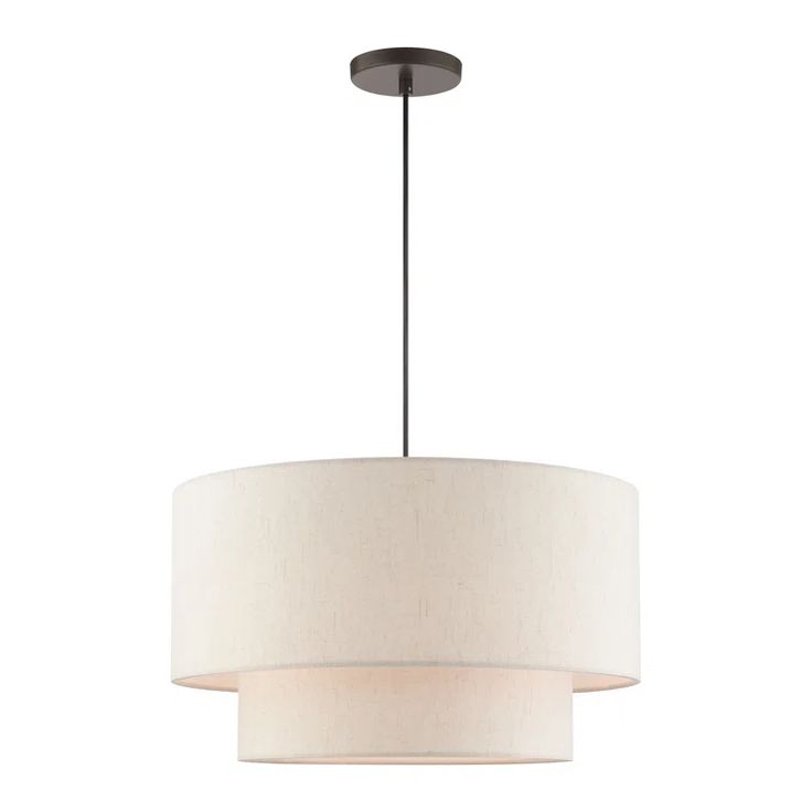 a light fixture with a white drum shade on the bottom and a black metal base