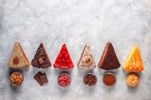 seven different types of food arranged in the shape of pyramids on a gray surface