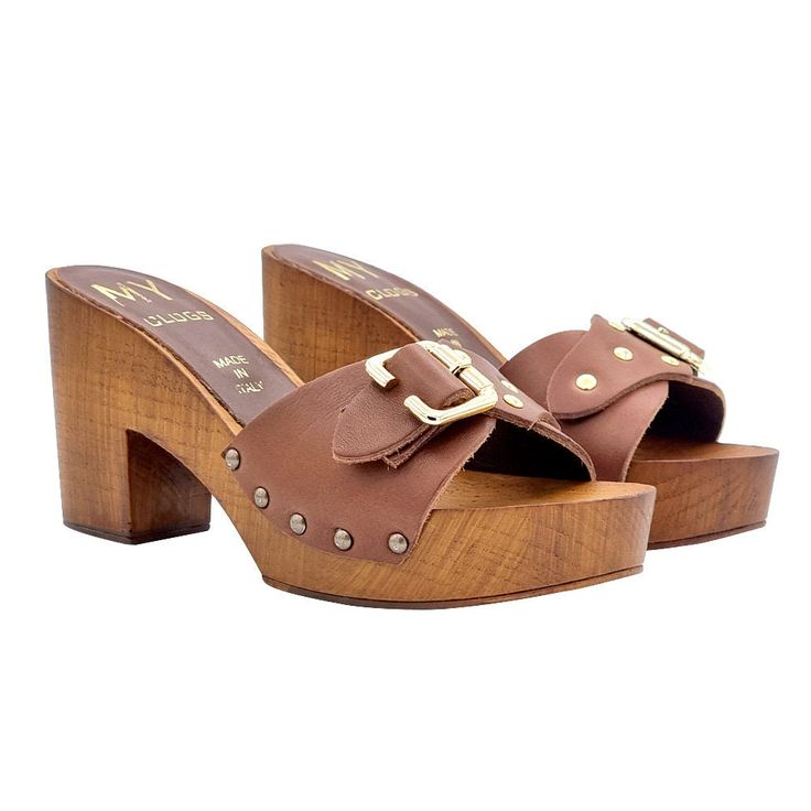 Women's clogs with brown wood effect base Brown leather band with buckle Comfortable 9 cm heel and 3 cm plateau Stable and comfortable made entirely in ITALY Craftsmanship. BEFORE COMPLETING YOUR PURCHASE DO NOT FORGET TO CHECK THE SIZE! Brown Sandals With Block Heel And Tang Buckle, Leather Clogs With Buckle Closure And Block Heel, Brown Mules With Tang Buckle, Brown Leather Mules With Buckle Closure, Brown Open Heel Sandals With Buckle Closure, Brown Sandals With Brass Buckle, Brown Sandals With Buckle Closure And Open Heel, Brown Wooden Heels With Leather Sole, Brown Block Heel Mules With Heel Loop