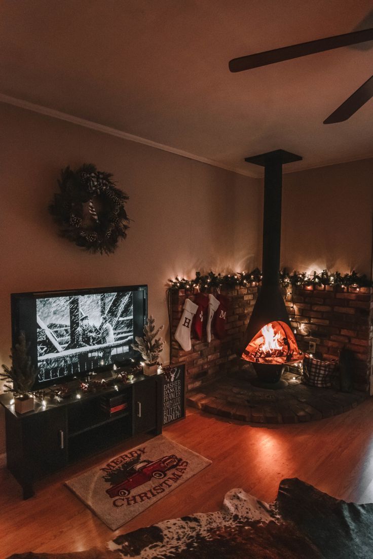 a living room filled with furniture and a flat screen tv next to a fire place