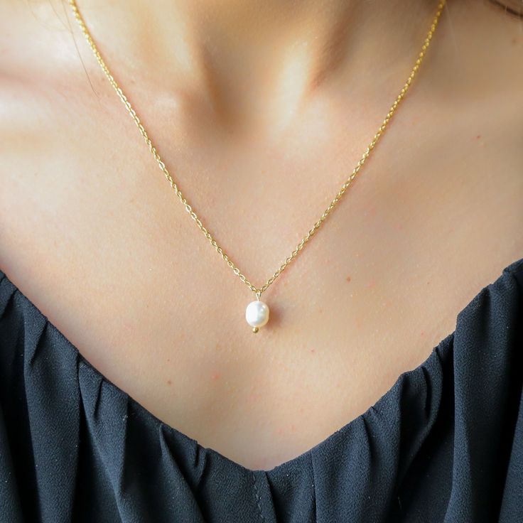 This exquisite necklace combines the luxury of 18k gold with the durability of sterling silver. The base of the necklace is crafted from premium 925 sterling silver, ensuring long-lasting quality, while the 18k gold plating adds a layer of rich, warm luster. The necklace features a sleek, modern design that effortlessly enhances any outfit, from casual to elegant. Its smooth, polished finish gives it a radiant glow, making it a perfect accessory for both day and night. Whether worn alone or laye Elegant Gold Charm Necklace With Clavicle Chain, Elegant Gold Charm Necklaces With Clavicle Chain, Gold Plated Charm Necklace With Pearl Drop, Classic Gold Charm Necklace With Pearl Drop, Elegant Gold Plated Pearl Charm Necklace, Gold-plated Necklaces With Pearl Drop, Elegant Gold Charm Necklace With Pearl Pendant, Elegant Gold-plated Pearl Charm Necklace, Dainty Gold Plated Necklace With Pearl Pendant