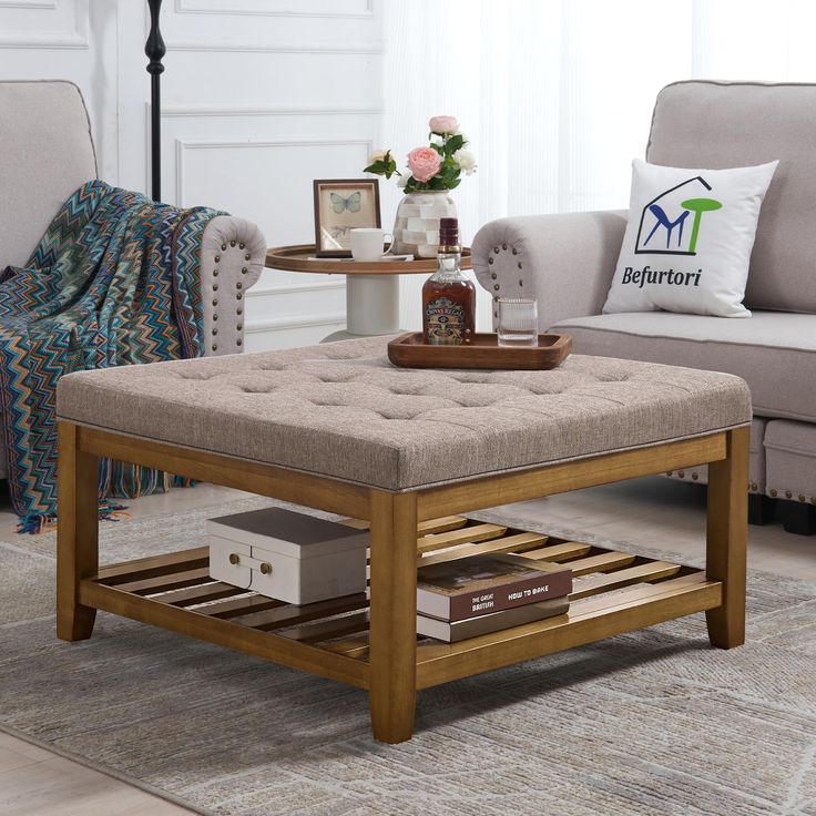 a living room with two couches, a coffee table and a rug on the floor