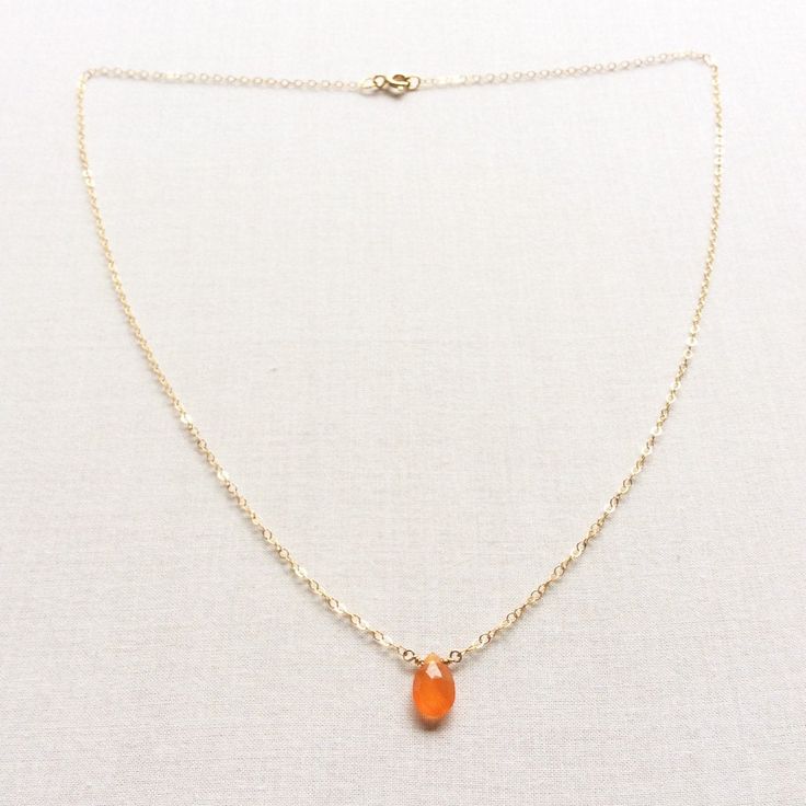 "This Carnelian necklace is made of genuine high quality faceted Carnelian. There are gold filled ,sterling silver and 14kt gold chain you can choose from. There are 2 sizes that you can choose from 16\" or 18\" in gold filled, sterling silver or 14k gold. This tiny carnelian necklace is light weight and elegant. The Carnelian jewelry stone is around 1.5 carats. This tiny carnelian necklace is great for layering with other gold necklaces. This orange stone necklace is delicate and perfect to go Orange Carnelian Crystal Necklace As Gift, Orange Carnelian Gemstone Necklace, Orange Carnelian Crystal Necklace For Gift, Gift Carnelian Crystal Necklace In Orange, Orange Carnelian Crystal Necklace Gift, Orange Chalcedony Jewelry For Gifts, Gift Chalcedony Faceted Necklaces, Orange Faceted Carnelian Necklaces, Amber Carnelian Necklace With Birthstone