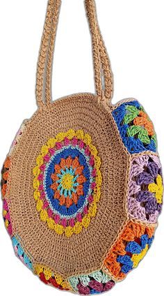 a crocheted bag with multicolored circles on the front and sides, hanging from a hook