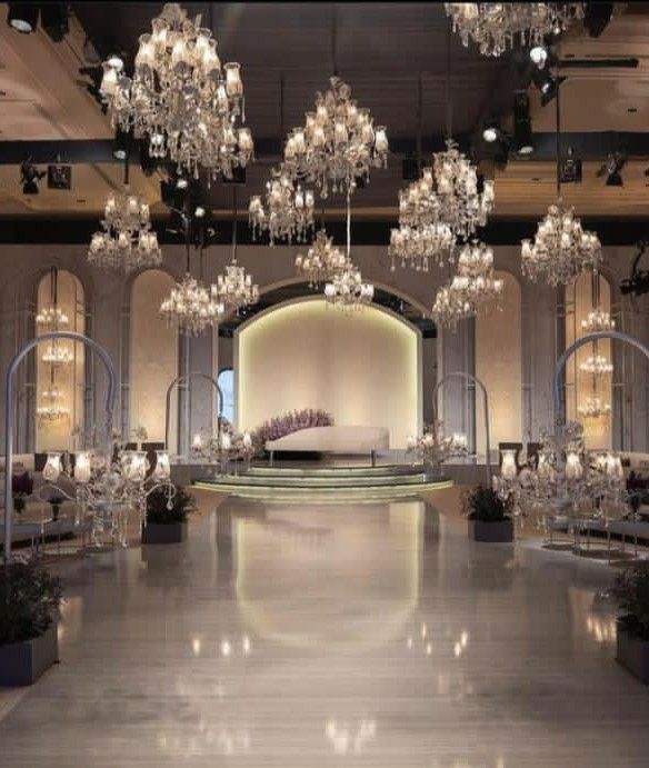 a large room with chandeliers hanging from the ceiling