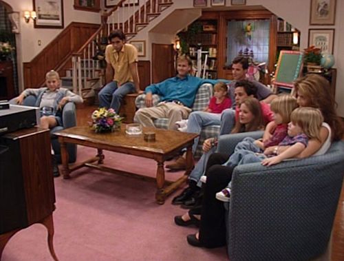 a group of people sitting around a living room together