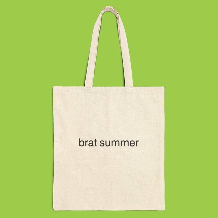 a tote bag with the words brat summer printed on it, against a green background