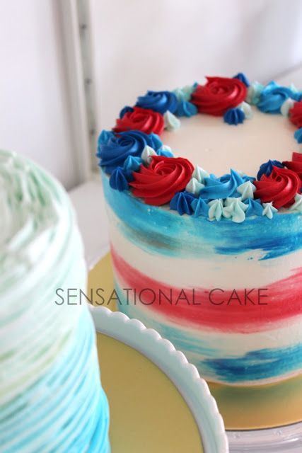 a cake with red, white and blue frosting on it sitting on a plate