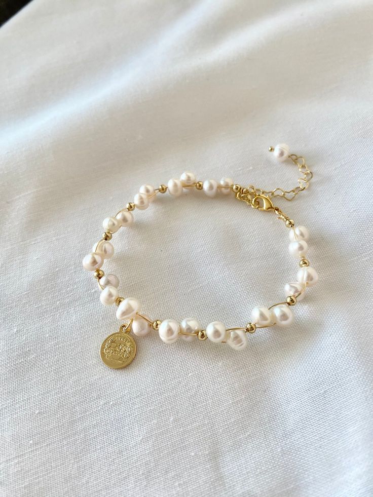 A bold pearl bracelet you can wear on special occasions like weddings or anniversaries. Perfect as gift for someone special. Made with real genuine pearls. Individual pearls measure approx 5-6mm each. 18k gold plated charms and metal findings. Adjustable closure fits wrist sizes 6- 7.5 inches.  Perfect as  Mother's Day gift, anniversaries, weddings, birthdays, Christmas, or any special occasion.  Please note that no two gemstones or pearls are exactly alike. Please allow for minor differences.  Discount for multiple orders available. Please contact me through etsy convo. Mother Of The Bride Jewelry Gold, Adjustable Bracelet With Pearl Pendant, Adjustable Pearl Bracelets With Pearl Pendant, Adjustable Pearl Bracelet With Pearl Pendant, Pearl Chain Bracelet For Wedding, Wedding Pearl Chain Bracelet, Elegant Charm Bracelet With Pearl And Round Beads, Handmade Pearl Bracelet Perfect For Gifts, Handmade Pearl Bracelet As Gift