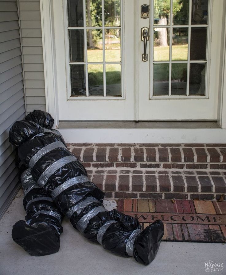 a pile of garbage sitting on top of a door mat in front of a house