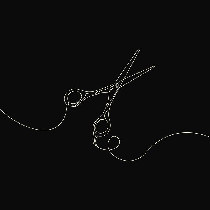 a pair of scissors that are sitting in the dark with some thread on it's side