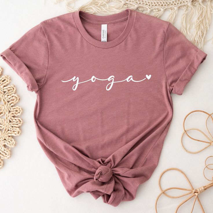 Cute Yoga Shirt! This shirt is the perfect tee for yoga classes and for everyday wearing. Beautiful gift for a friend or for treat yourself, this shirt has a  cute and minimalist design, with a powerful practice: YOGA ❤ * DETAILS: T-shirts: Bella + Canvas - super soft and high quality shirts Material: Cotton/Poly Blend Design: is applied using high quality heat transfer vinyl and is applied to each shirt with a commercial grade heat press. Model: Unisex Sleeves: they are rolled up for display purposes only Printed in the USA *SIZING For sizing, please refer to the size chart in the pictures or contact us. Our t-shirts are unisex. Women should order one (1) size down if they prefer a slimmer fit. Size chart is included in images. *COLORS Color chart is available in images with all colors av Pink Athleisure T-shirt For Yoga, Sporty Yoga T-shirt With Letter Print, Casual Short Sleeve Tops For Pilates, Pink Sporty T-shirt For Yoga, Basic Crew Neck Yoga Top, Casual Tops With Name Print For Loungewear, Pink Short Sleeve Yoga Top, Pink Short Sleeve Tops For Yoga, Relaxed Fit Yoga T-shirt With Letter Print